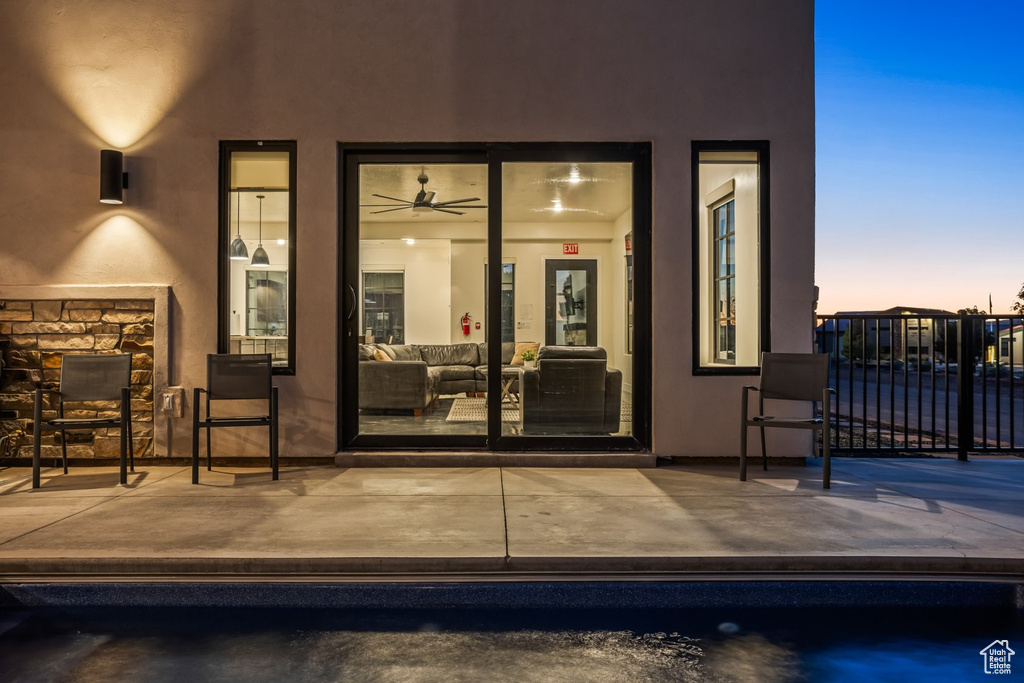 Exterior entry at dusk featuring ceiling fan