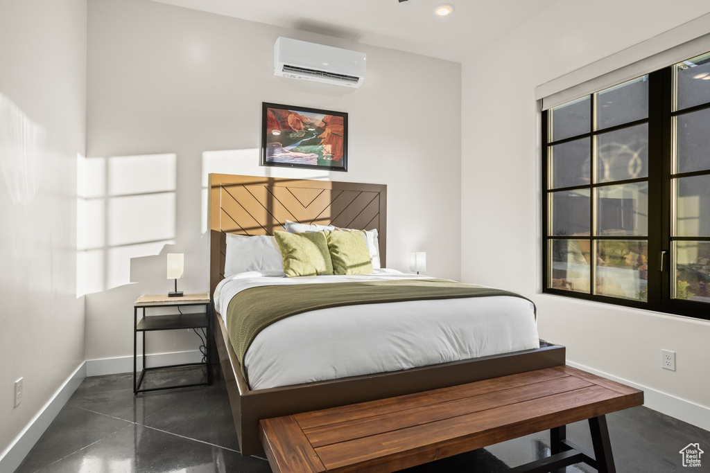 Bedroom with a wall mounted air conditioner