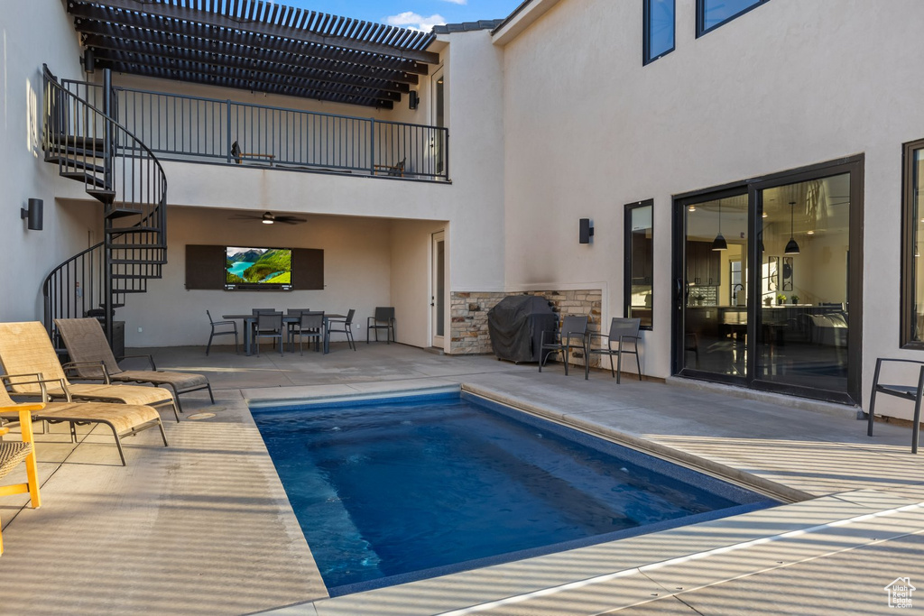 View of pool with area for grilling and a patio area