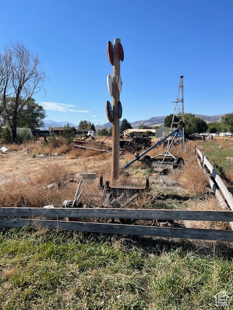 View of yard with a rural view and a mountain view