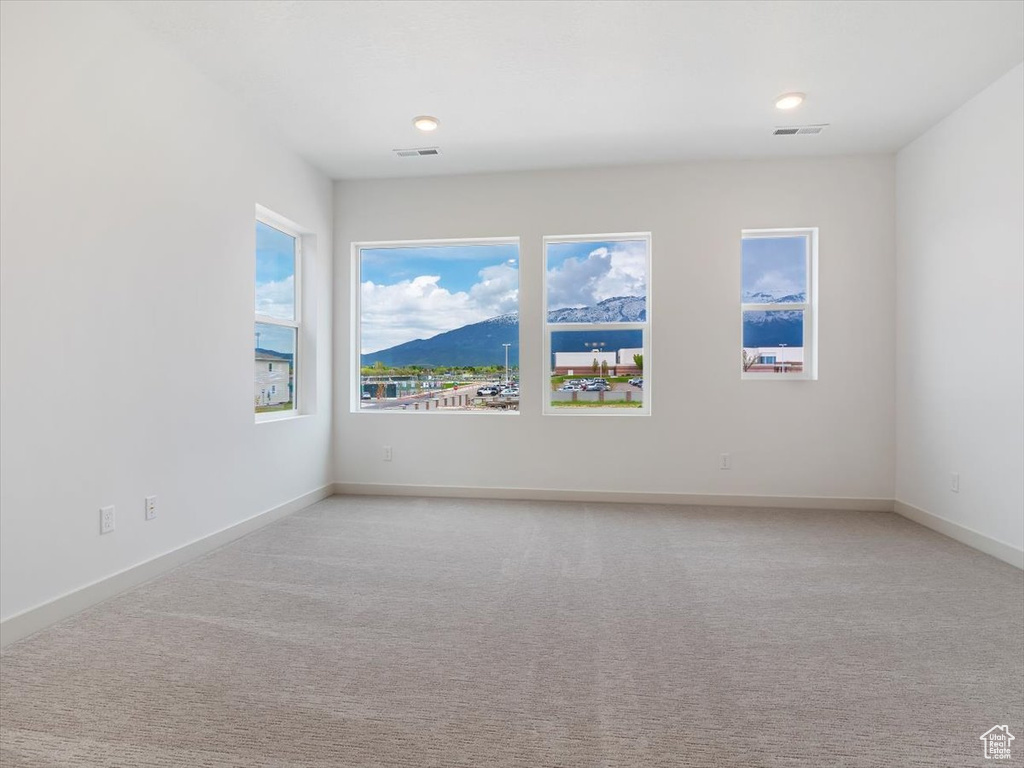 Carpeted empty room with a mountain view