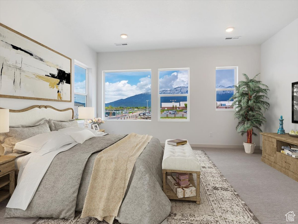 Bedroom featuring a mountain view, carpet, and multiple windows