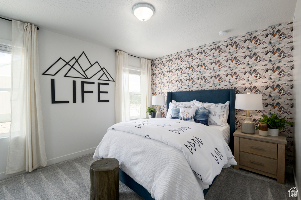 Carpeted bedroom with a textured ceiling