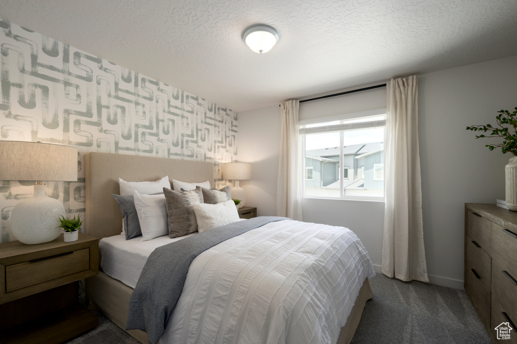 Carpeted bedroom featuring a textured ceiling