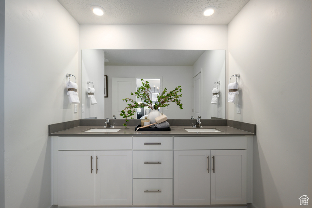 Bathroom with vanity and a textured ceiling