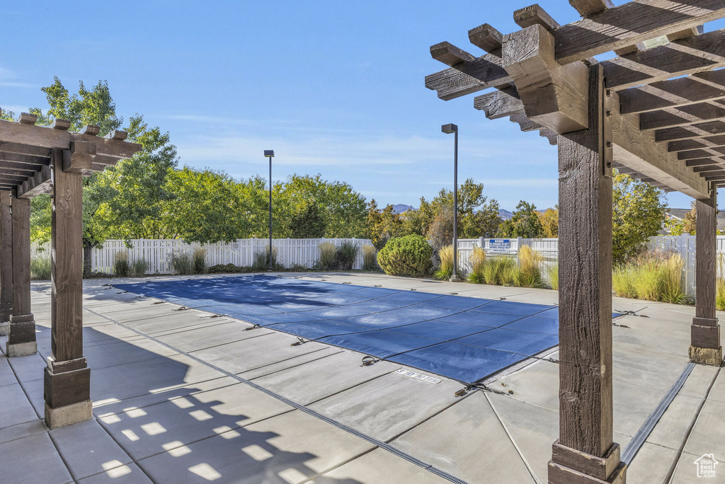 View of pool featuring a patio area and a pergola