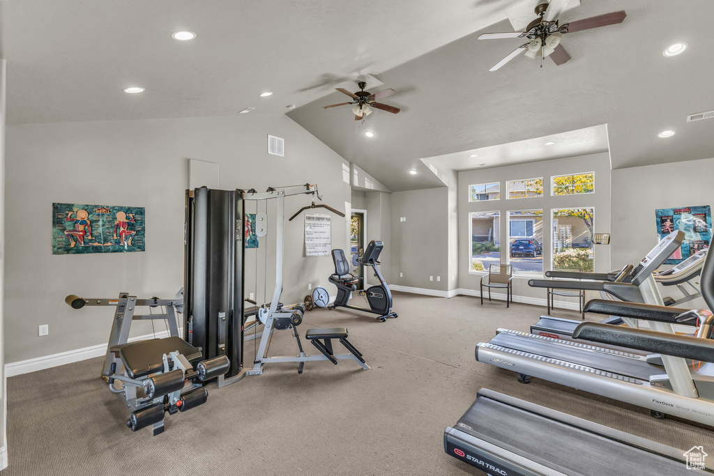 Exercise area with vaulted ceiling and ceiling fan