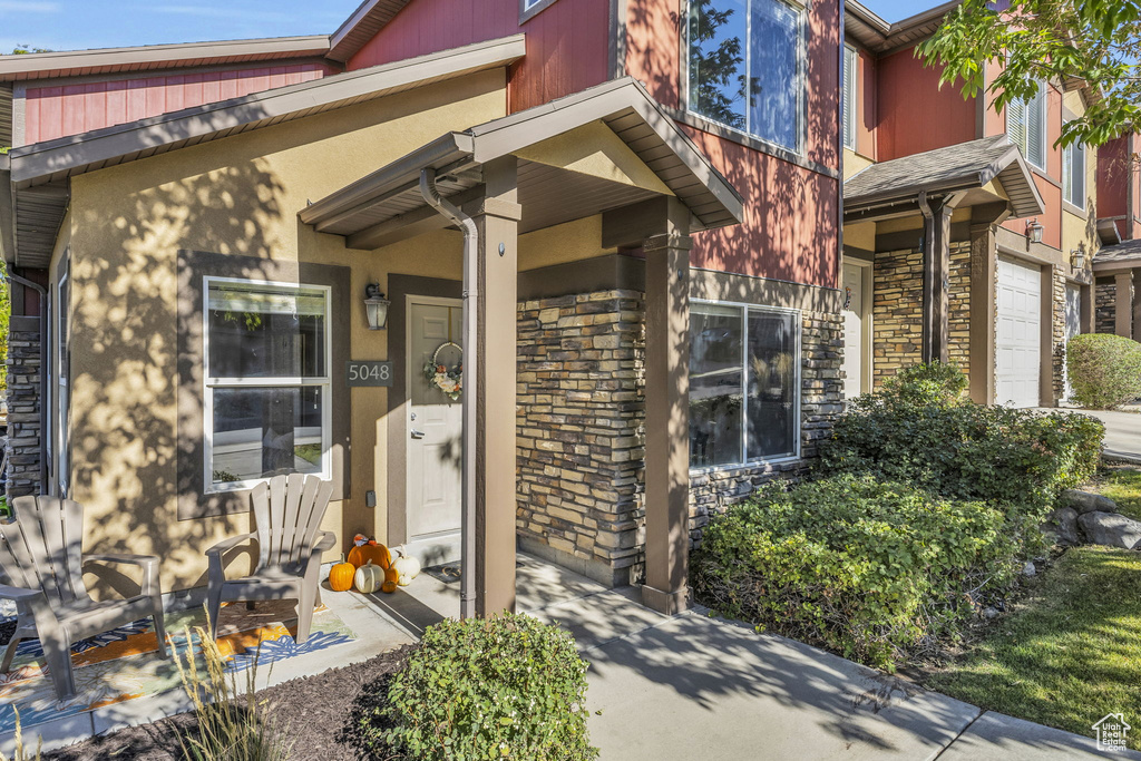 Doorway to property with a garage