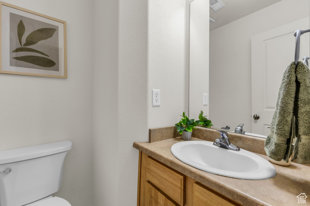 Bathroom featuring vanity and toilet