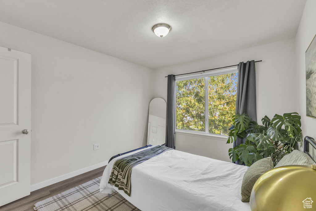 Bedroom featuring dark hardwood / wood-style flooring