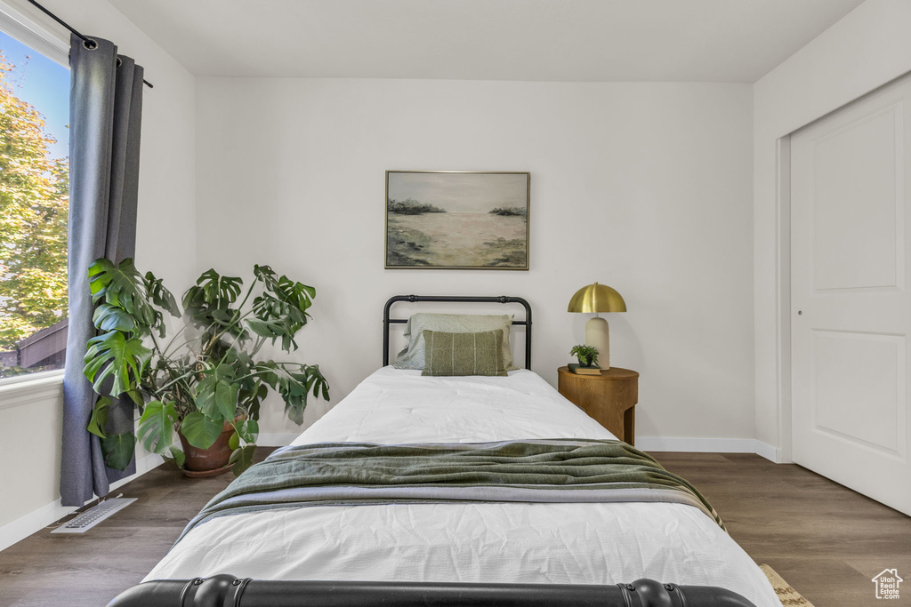 Bedroom with dark wood-type flooring