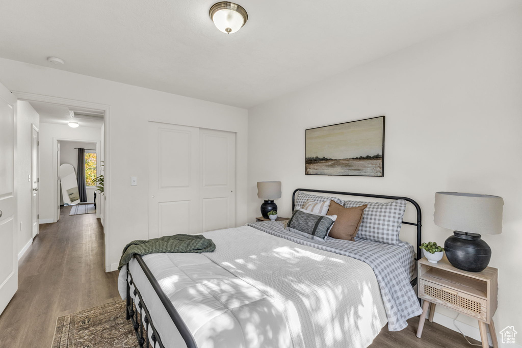 Bedroom featuring dark wood-type flooring and a closet