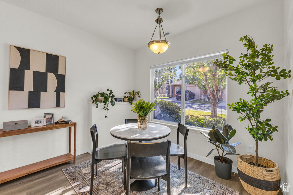 Dining area with dark wood-type flooring