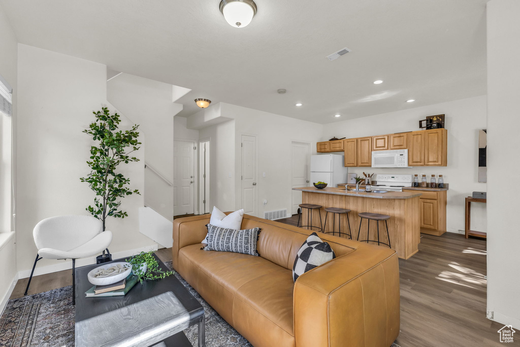 Living room with sink and hardwood / wood-style floors