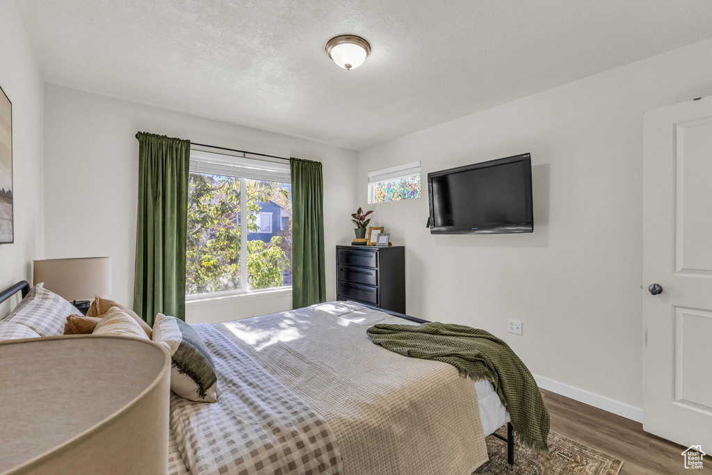 Bedroom featuring dark wood-type flooring and a textured ceiling