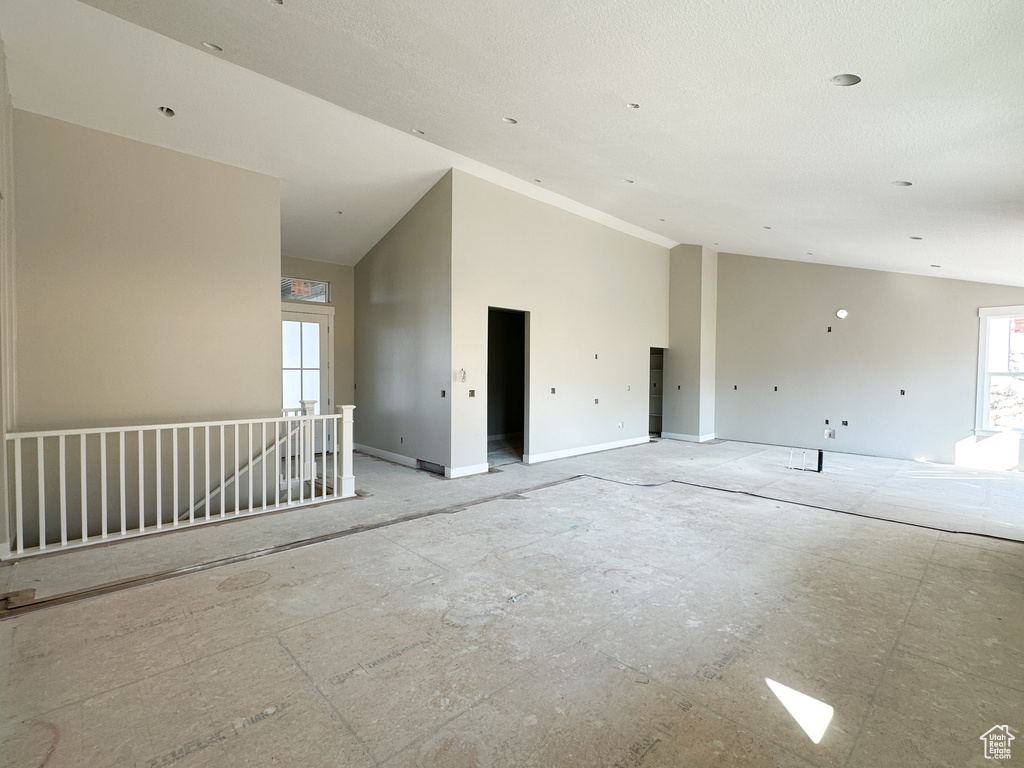 Empty room with lofted ceiling