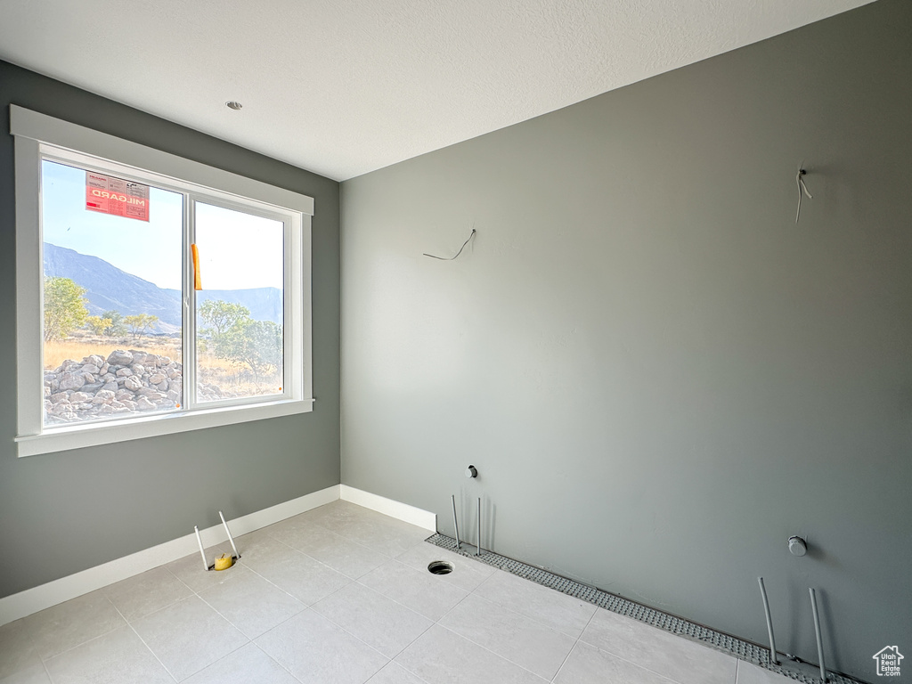 Tiled empty room featuring a mountain view