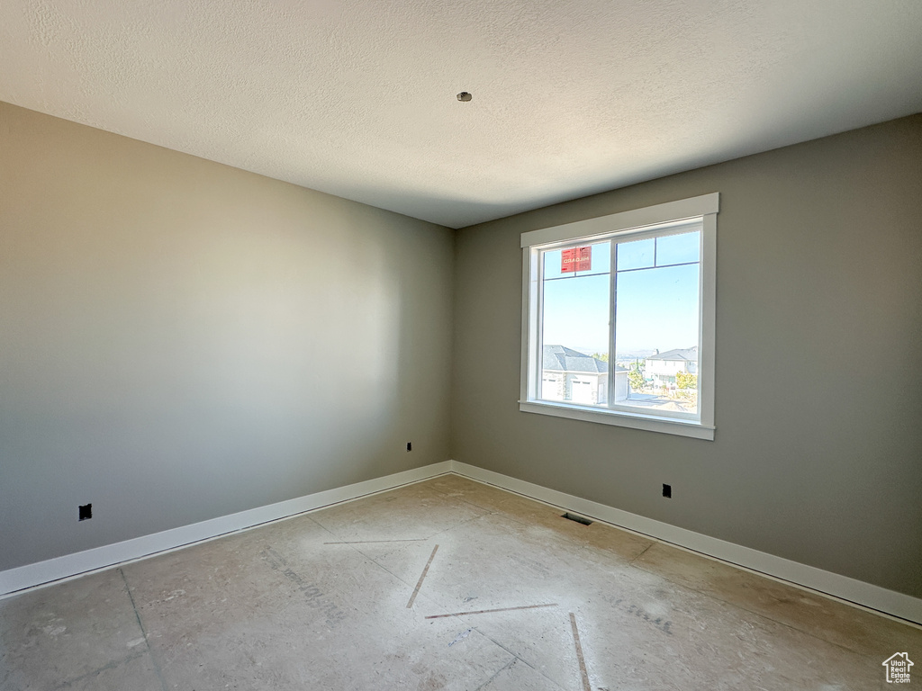 Empty room with a textured ceiling