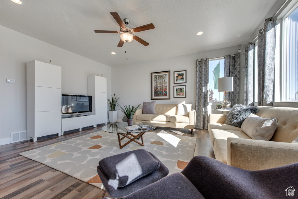 Living room with ceiling fan, hardwood / wood-style flooring, and plenty of natural light