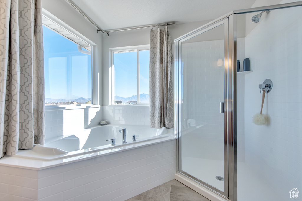 Bathroom featuring a mountain view and separate shower and tub