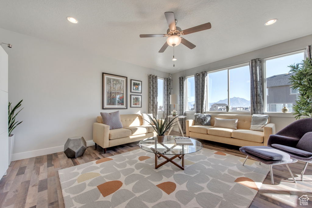 Living room featuring ceiling fan, a mountain view, and light hardwood / wood-style floors