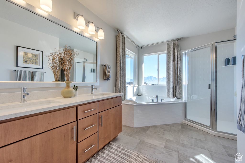 Bathroom with vanity, shower with separate bathtub, and tile patterned floors