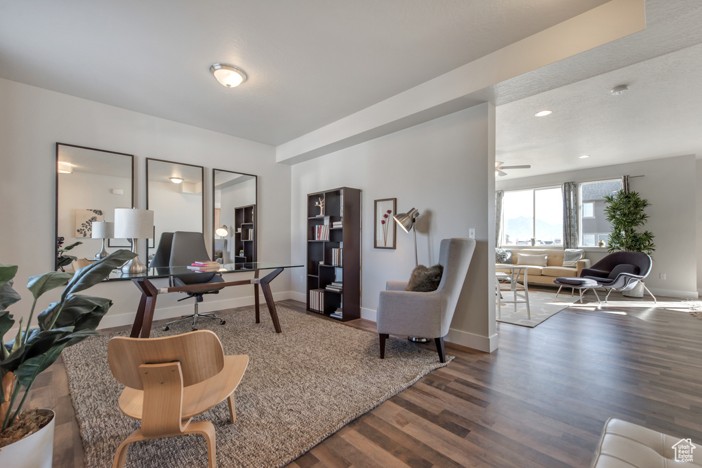 Office area with wood-type flooring and ceiling fan