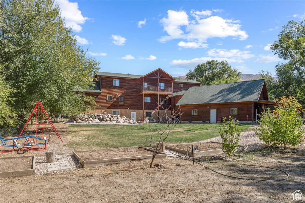 Rear view of house with a yard