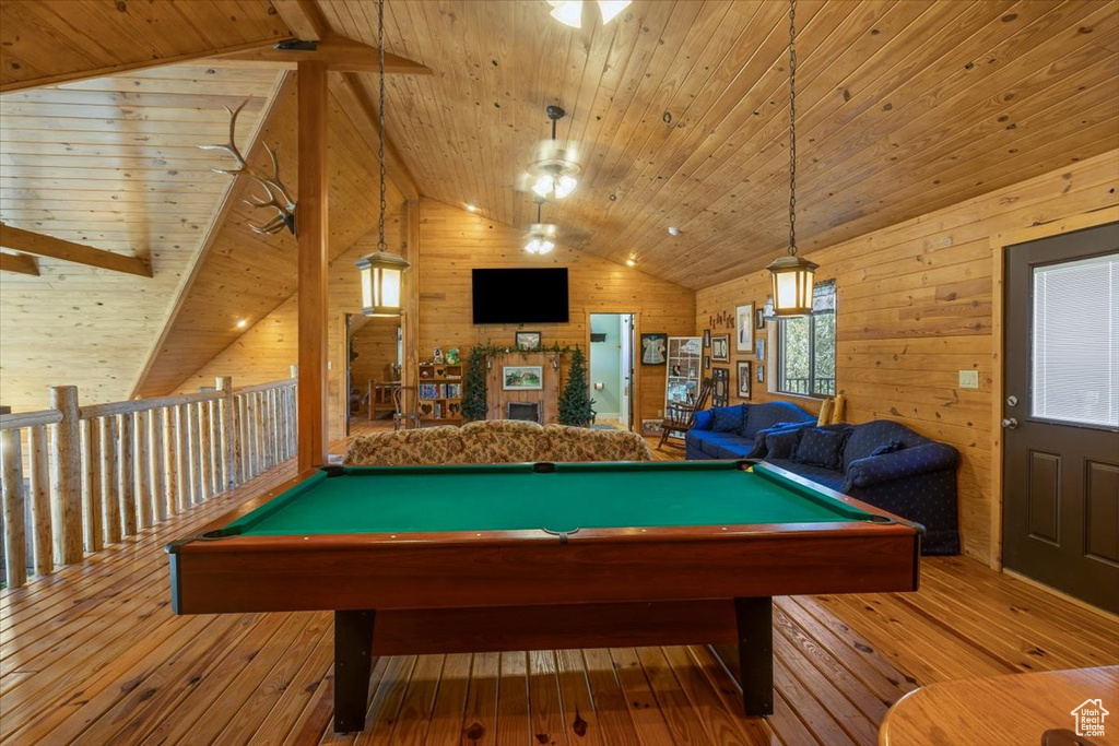 Playroom featuring wood-type flooring, wooden ceiling, vaulted ceiling, and wooden walls