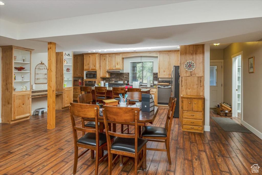 Dining area featuring dark hardwood / wood-style floors and built in desk