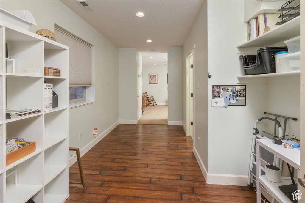 Hallway with dark hardwood / wood-style floors