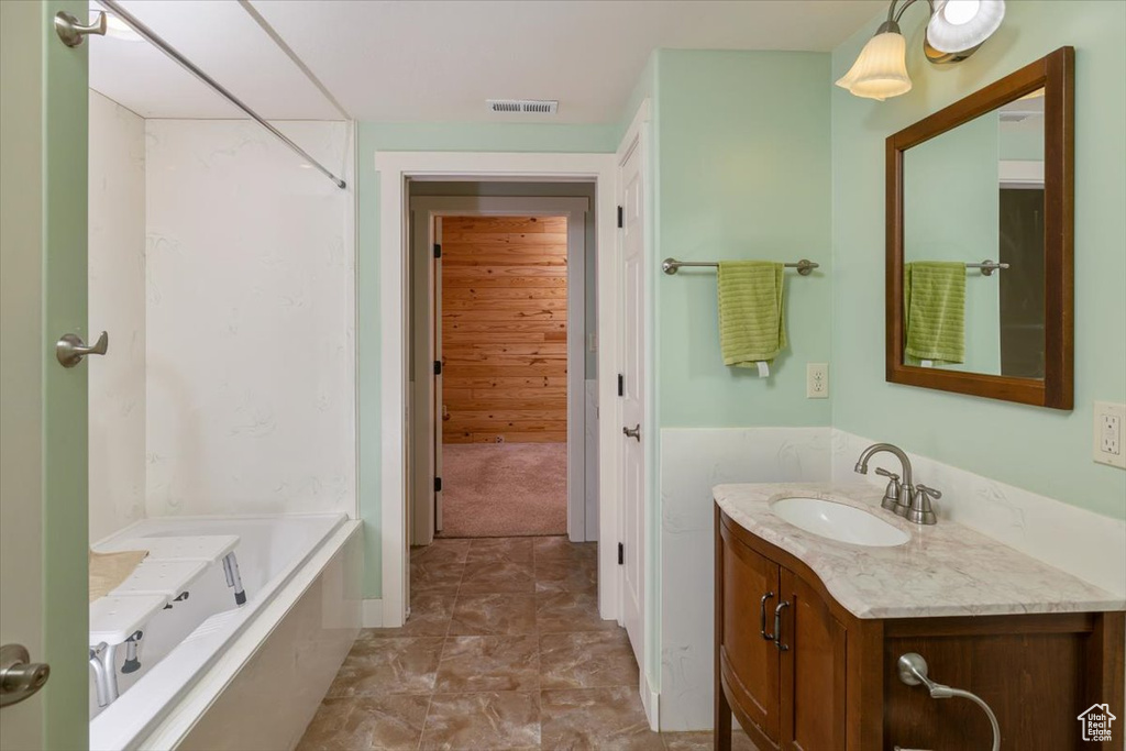 Bathroom featuring vanity and a tub to relax in