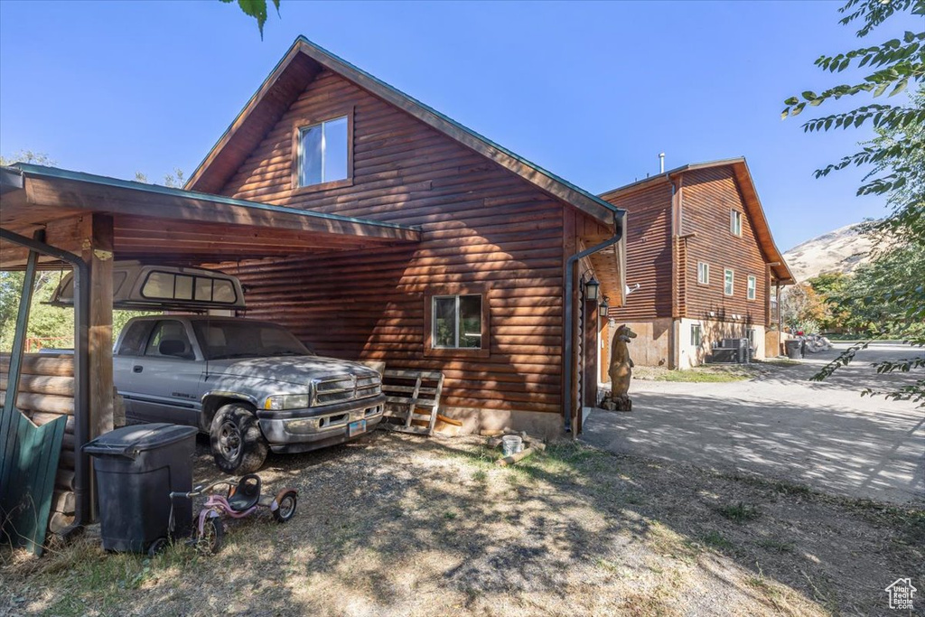 View of side of property featuring a carport