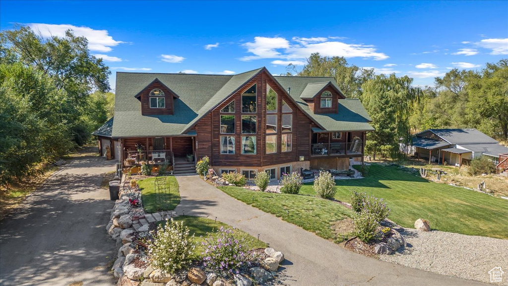 View of front of home with a front yard and covered porch