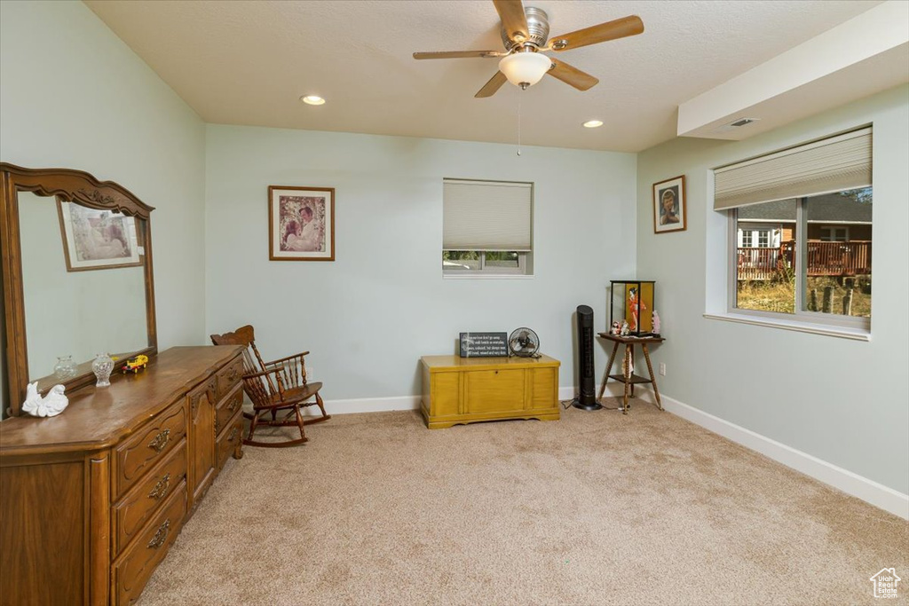 Sitting room featuring ceiling fan and light colored carpet