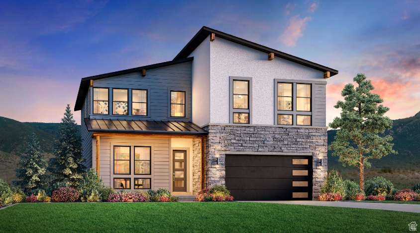 Modern home featuring a yard and a garage