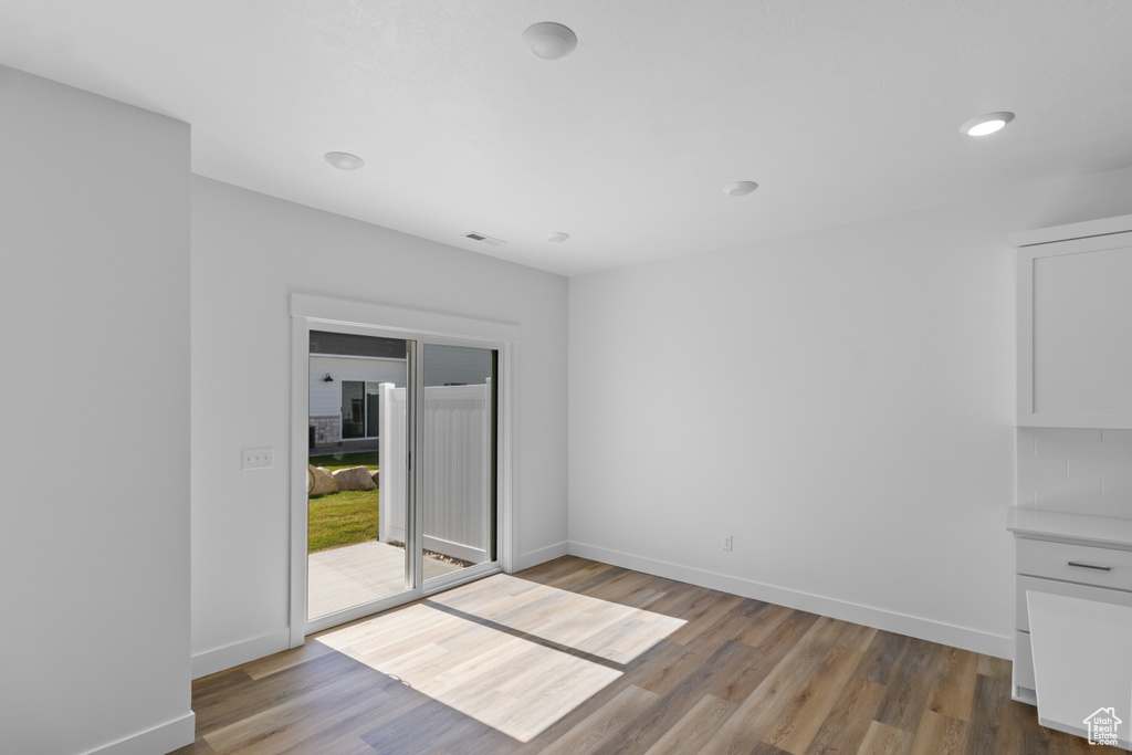 Unfurnished room featuring hardwood / wood-style floors