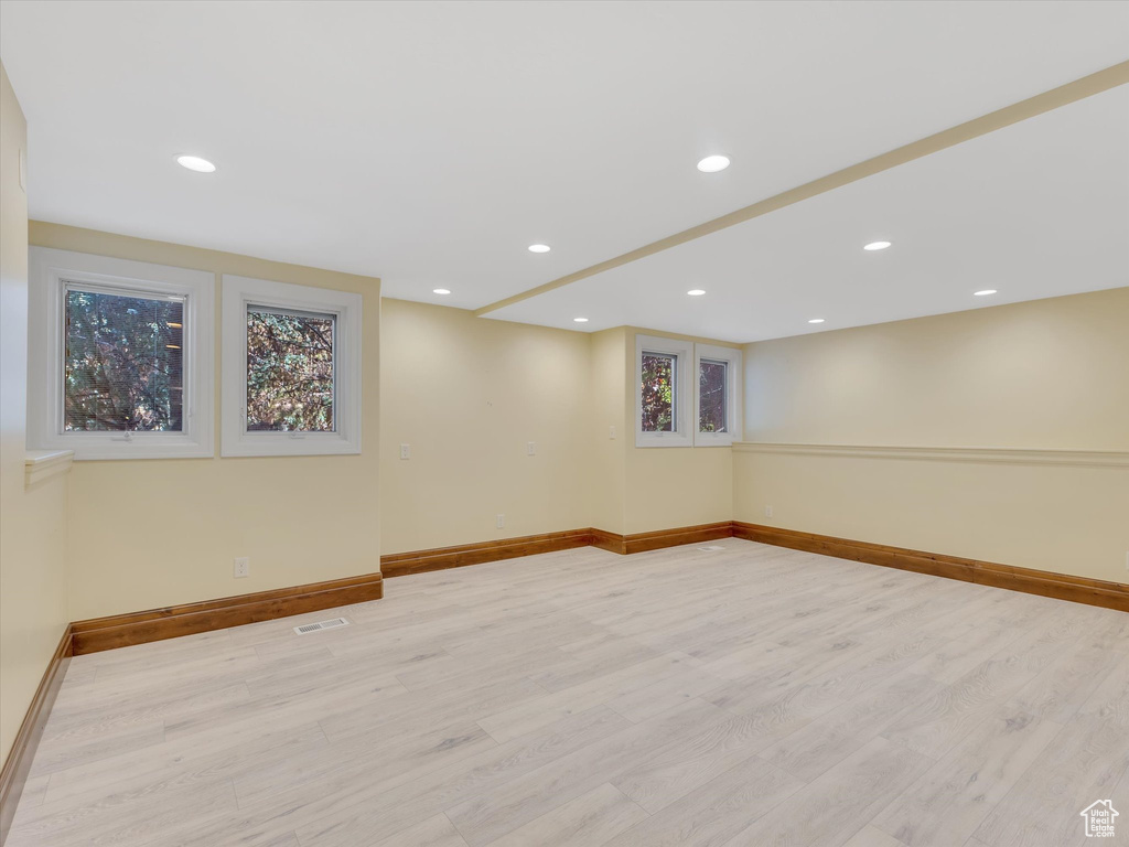 Basement with light wood-type flooring