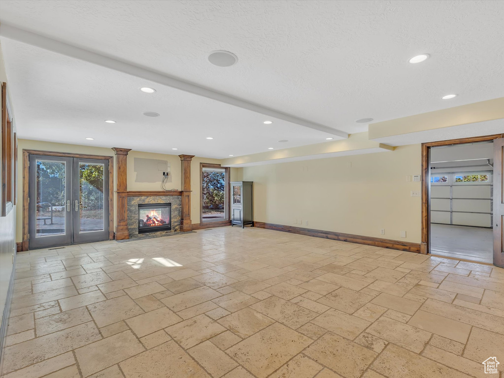 Unfurnished living room featuring french doors