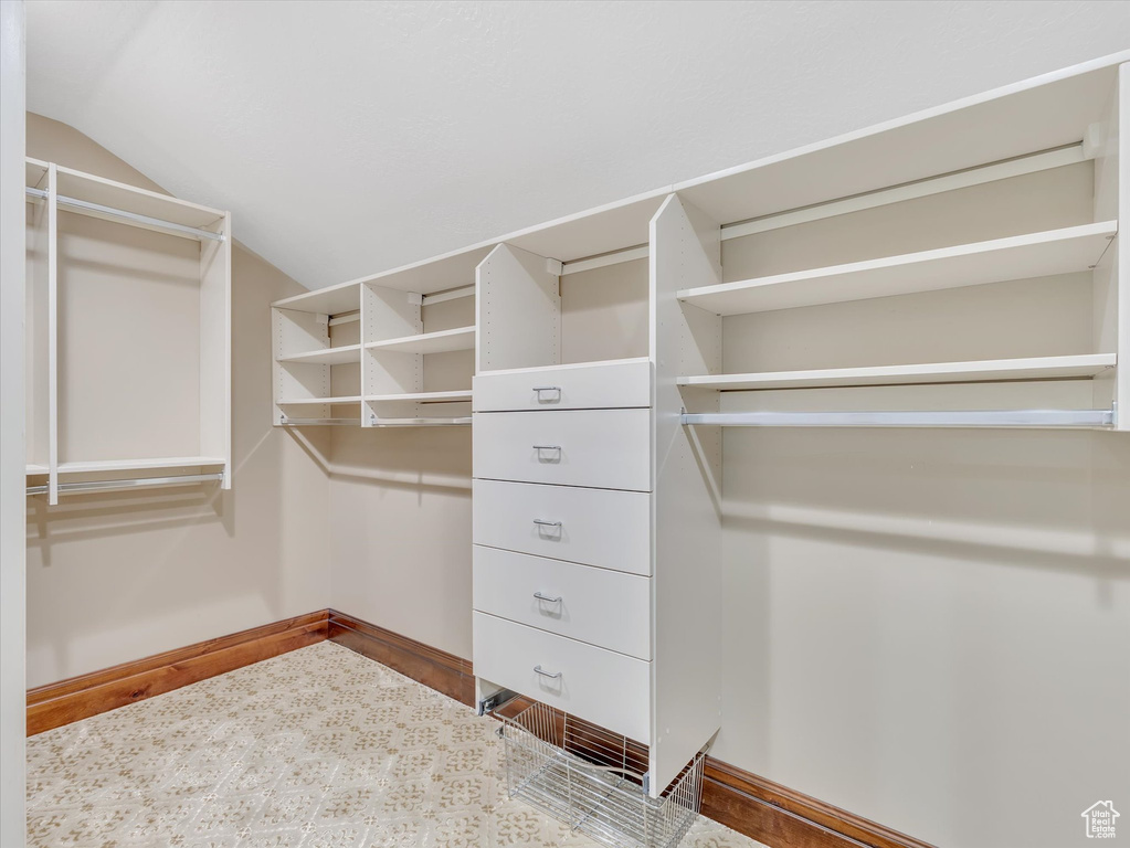 Walk in closet featuring lofted ceiling