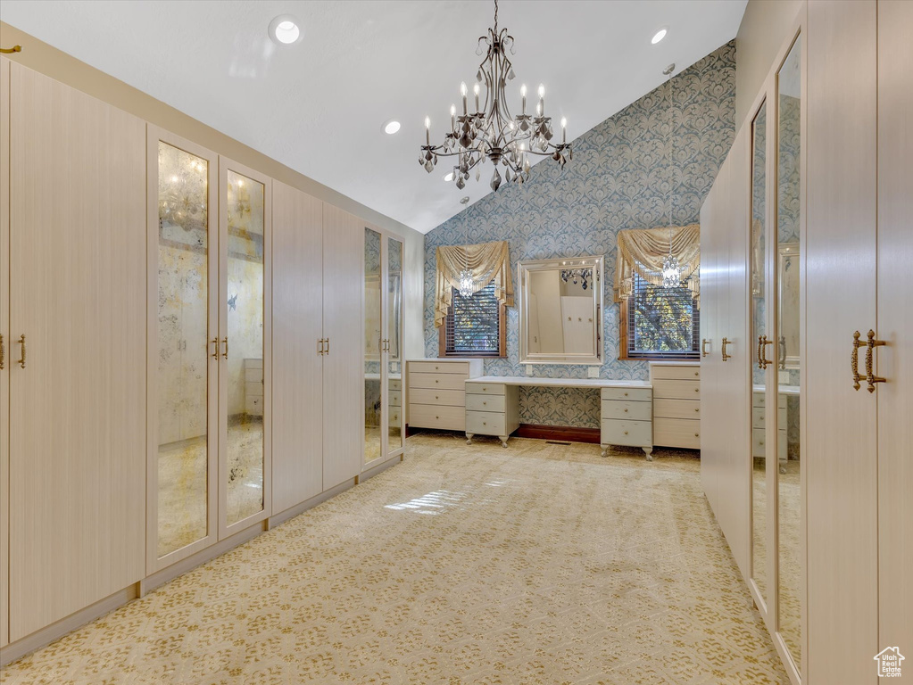 Bathroom featuring lofted ceiling and a chandelier