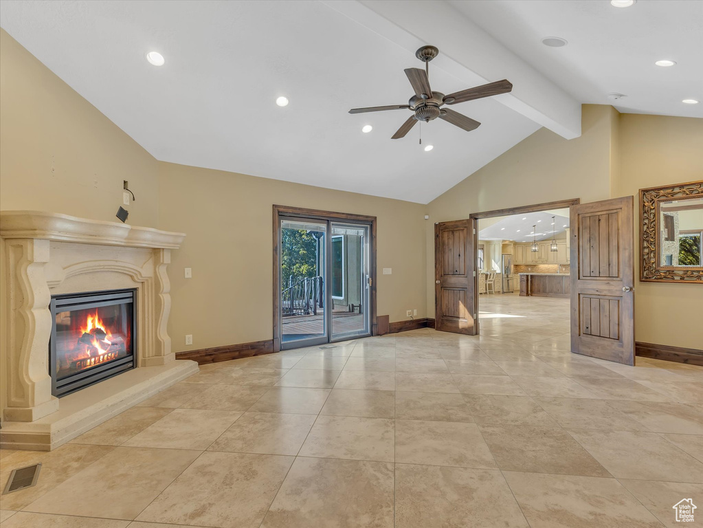 Unfurnished living room with lofted ceiling with beams and ceiling fan