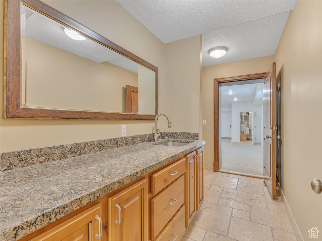 Bathroom featuring vanity and a textured ceiling