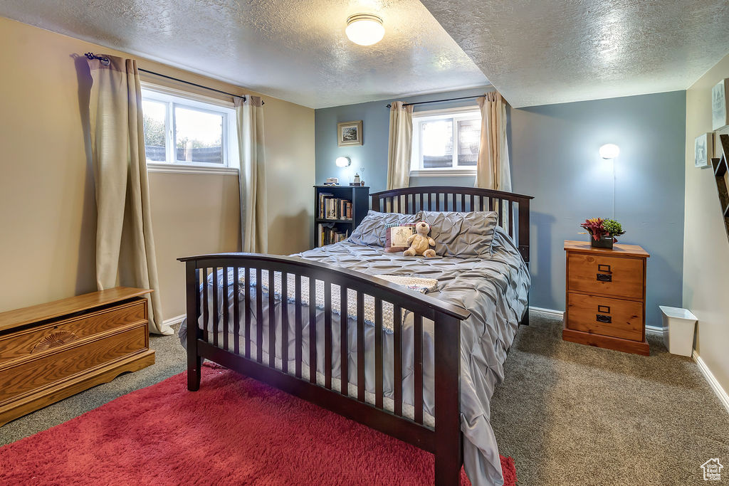 Carpeted bedroom featuring a textured ceiling