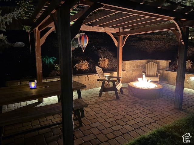 View of patio with a pergola and an outdoor fire pit