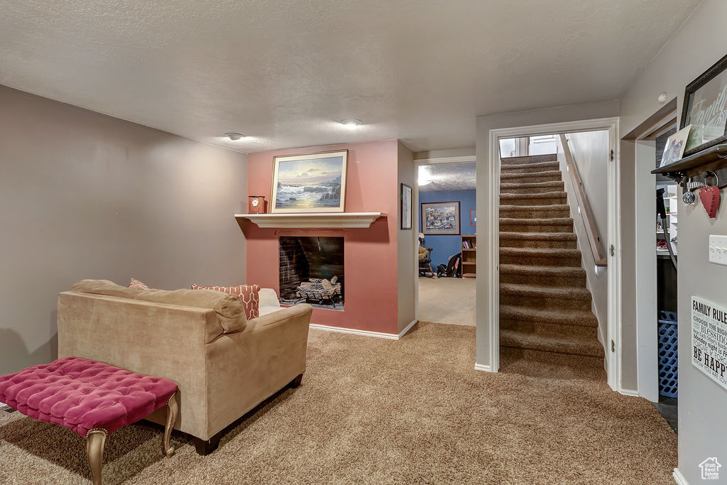 Carpeted living room with a textured ceiling