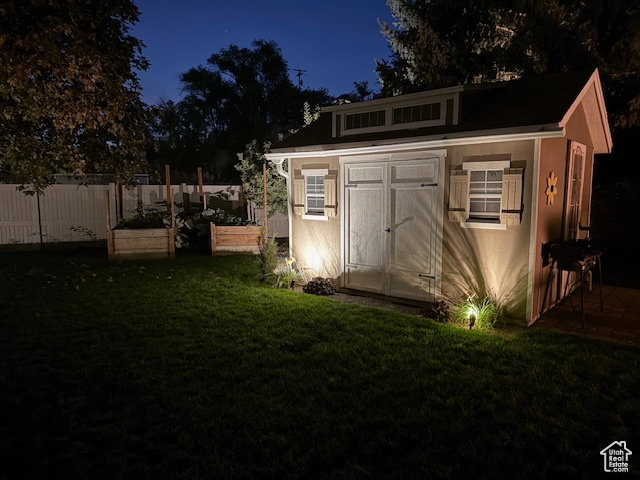 View of outbuilding with a lawn