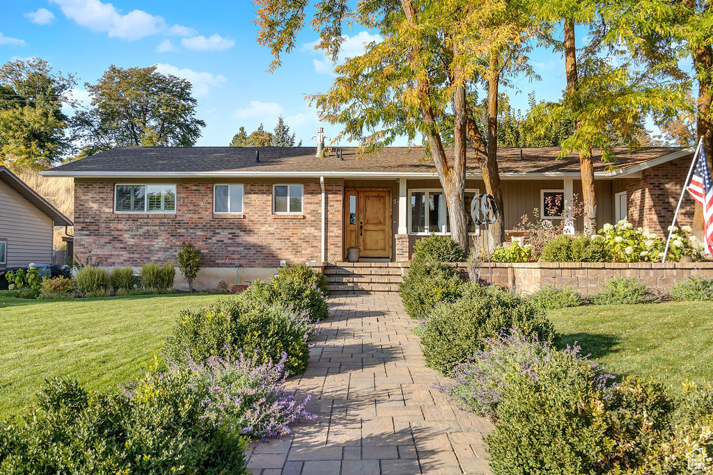 Ranch-style home with a front lawn