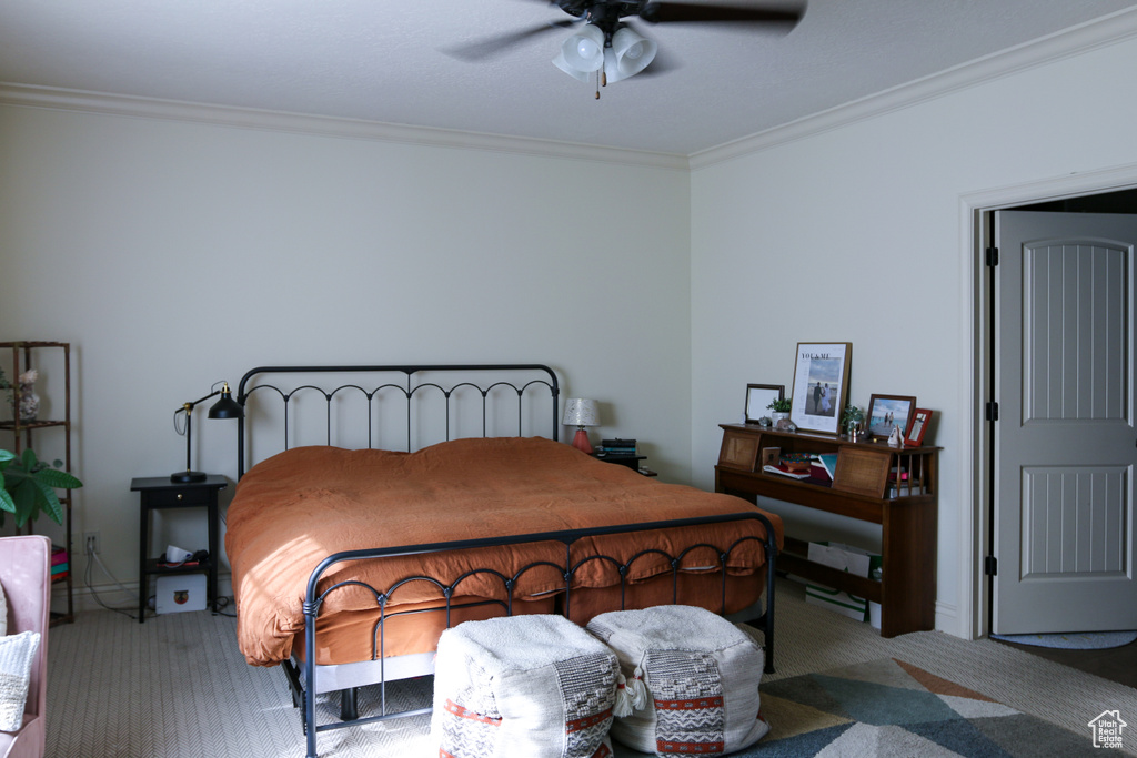 Bedroom featuring ornamental molding, ceiling fan, and carpet flooring