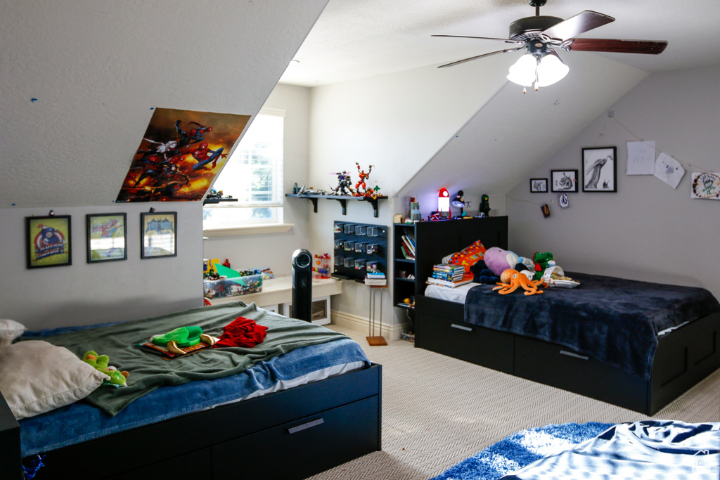 Bedroom featuring lofted ceiling, ceiling fan, and light colored carpet